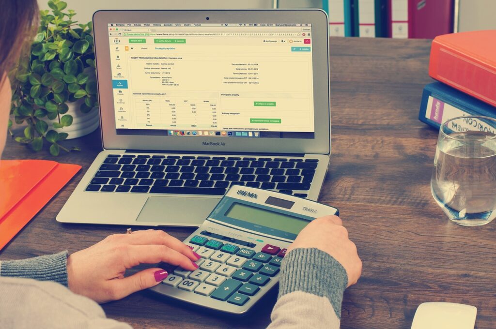 A financial expert reconciling accounts and reviewing financial reports for accurate bookkeeping.